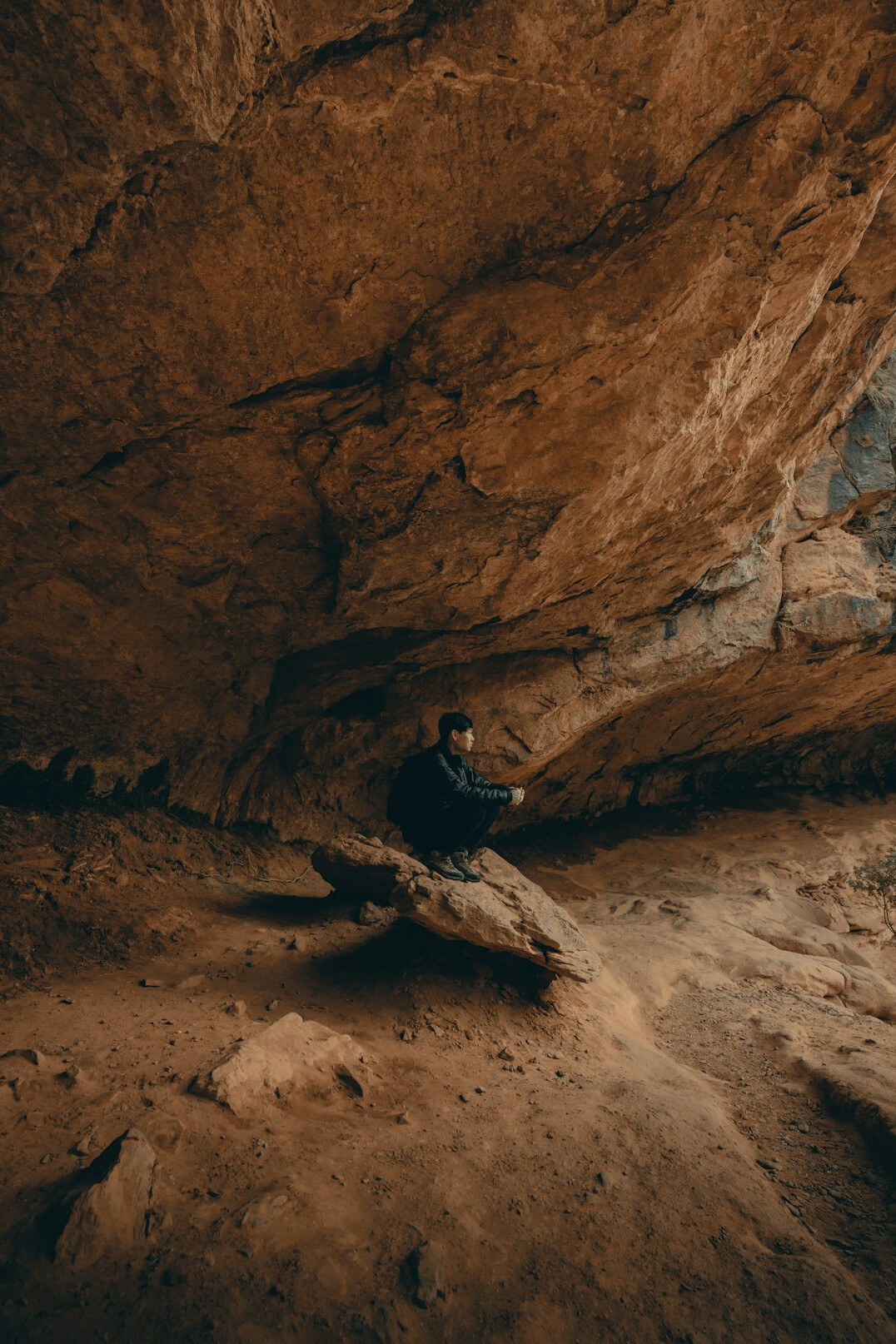 explorer with flashlight in cave